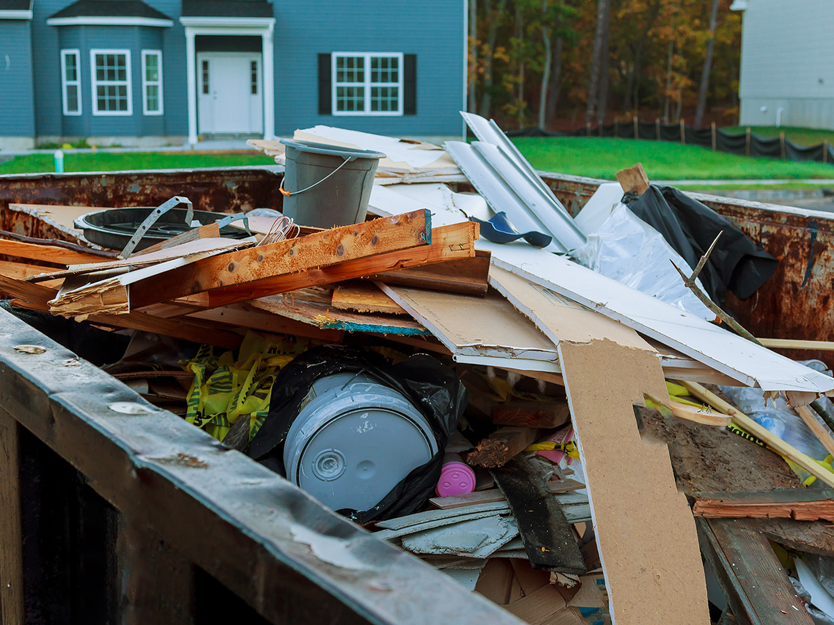 Dumpster in front of home holding discarded remodeling materials
