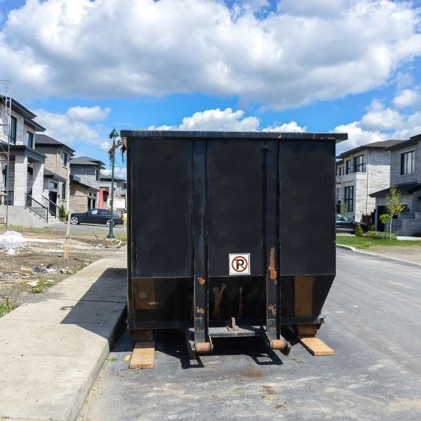 Dumpster on flat concrete suface.